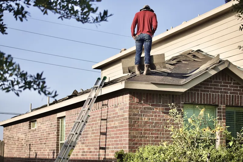 Professional roofer working on a residential roof in Villa Madonna